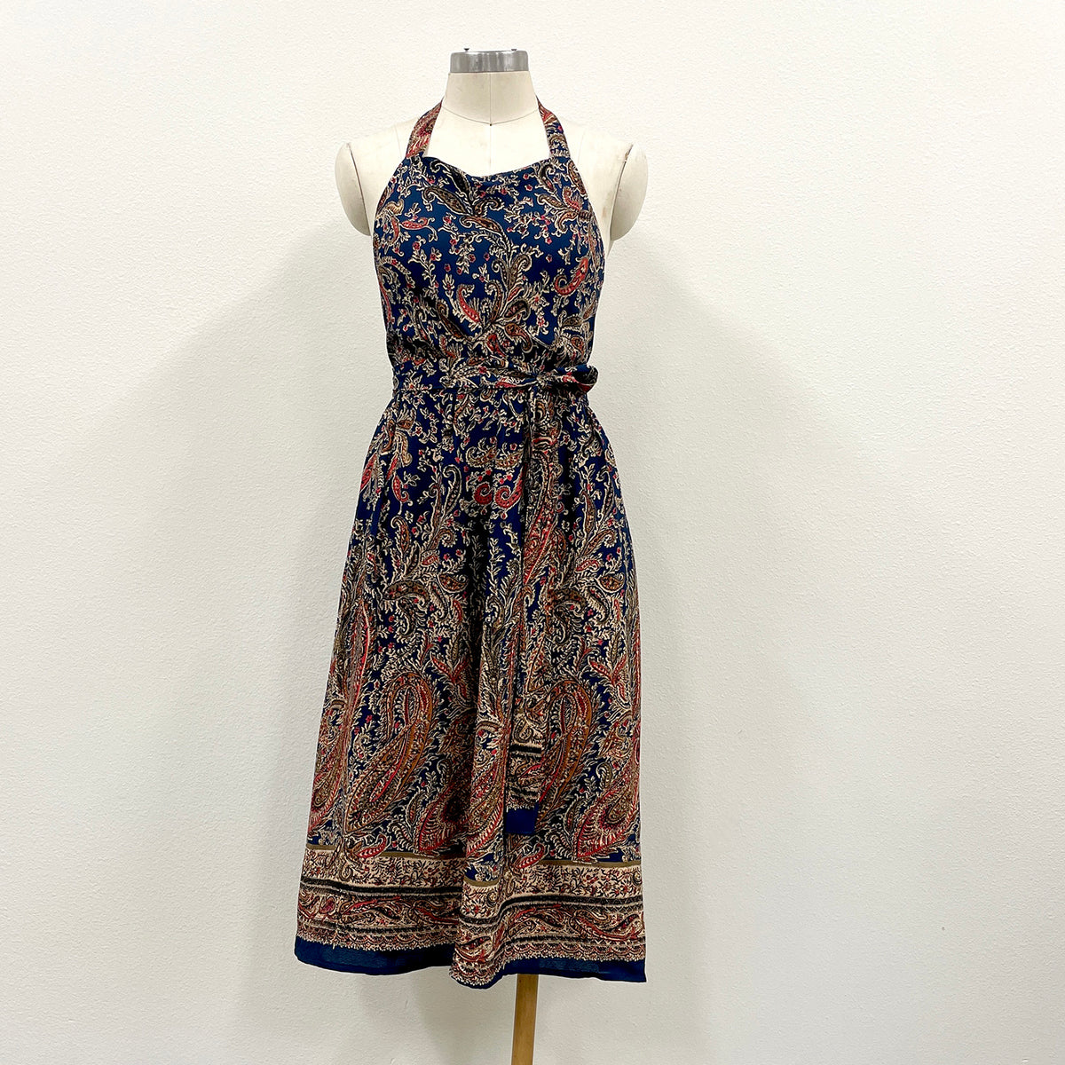 Patterned halter dress on a mannequin against a white background