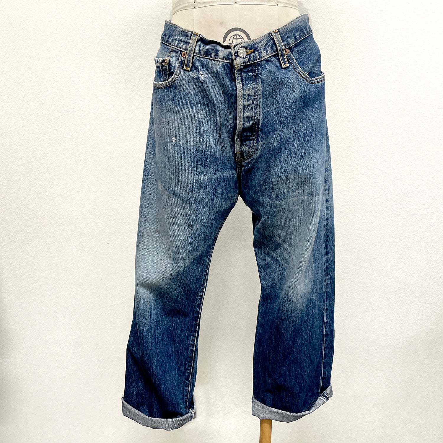 Blue jeans on a mannequin against a white background