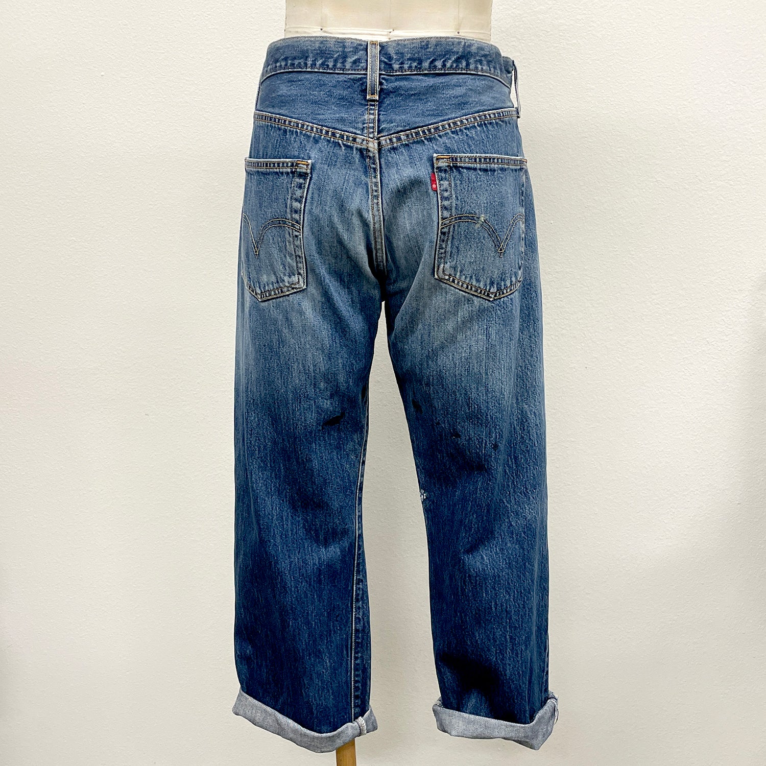 Blue jeans on a mannequin against a white background