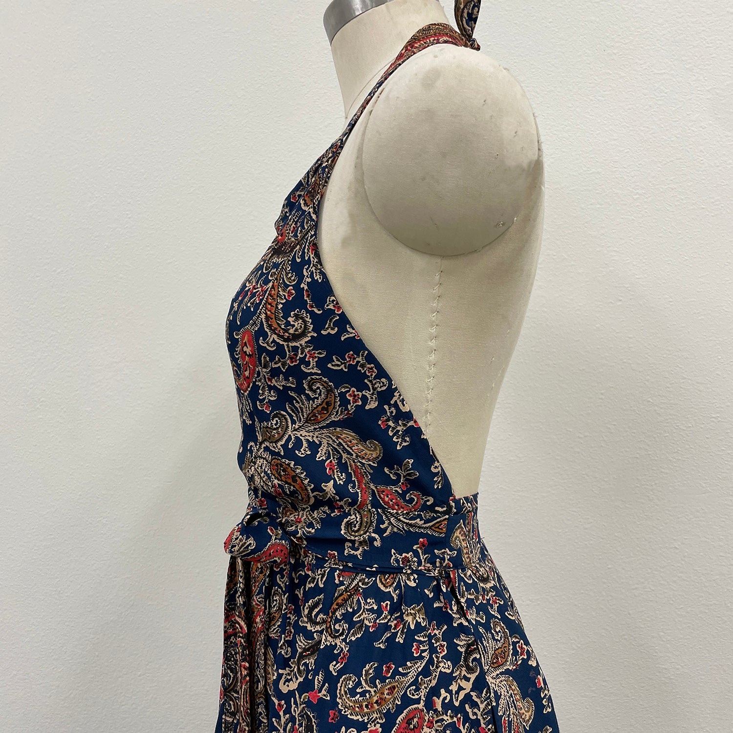 Mannequin wearing a blue patterned dress against a white background