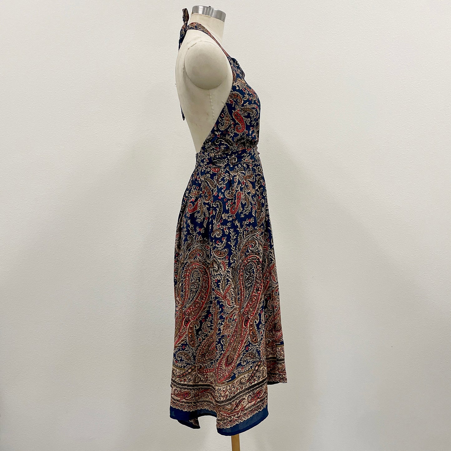 Paisley patterned dress on a mannequin against a white background