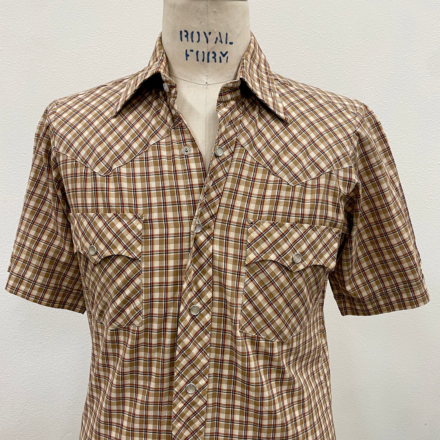 Plaid shirt on a mannequin with 'Royal Fur' branding against a white background