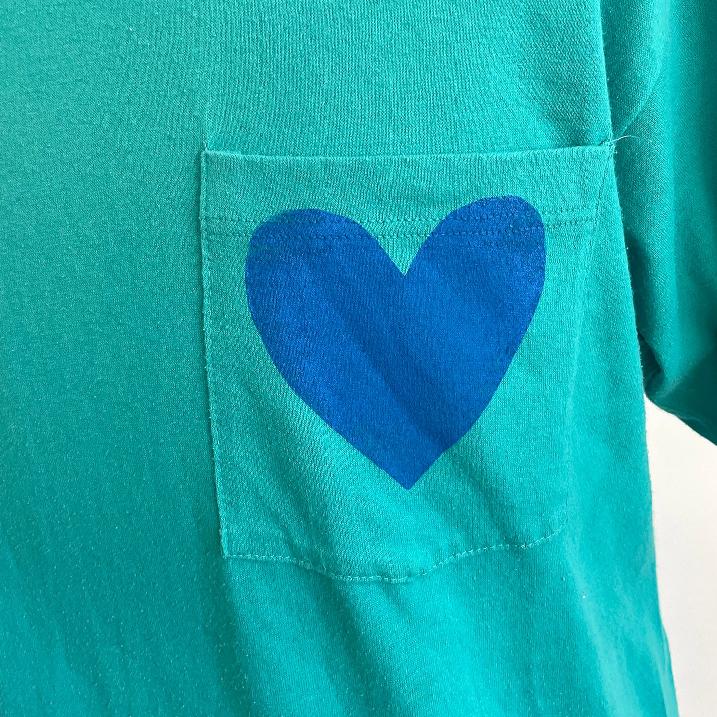 Vintage Happy Heart Teal Pocket Tee