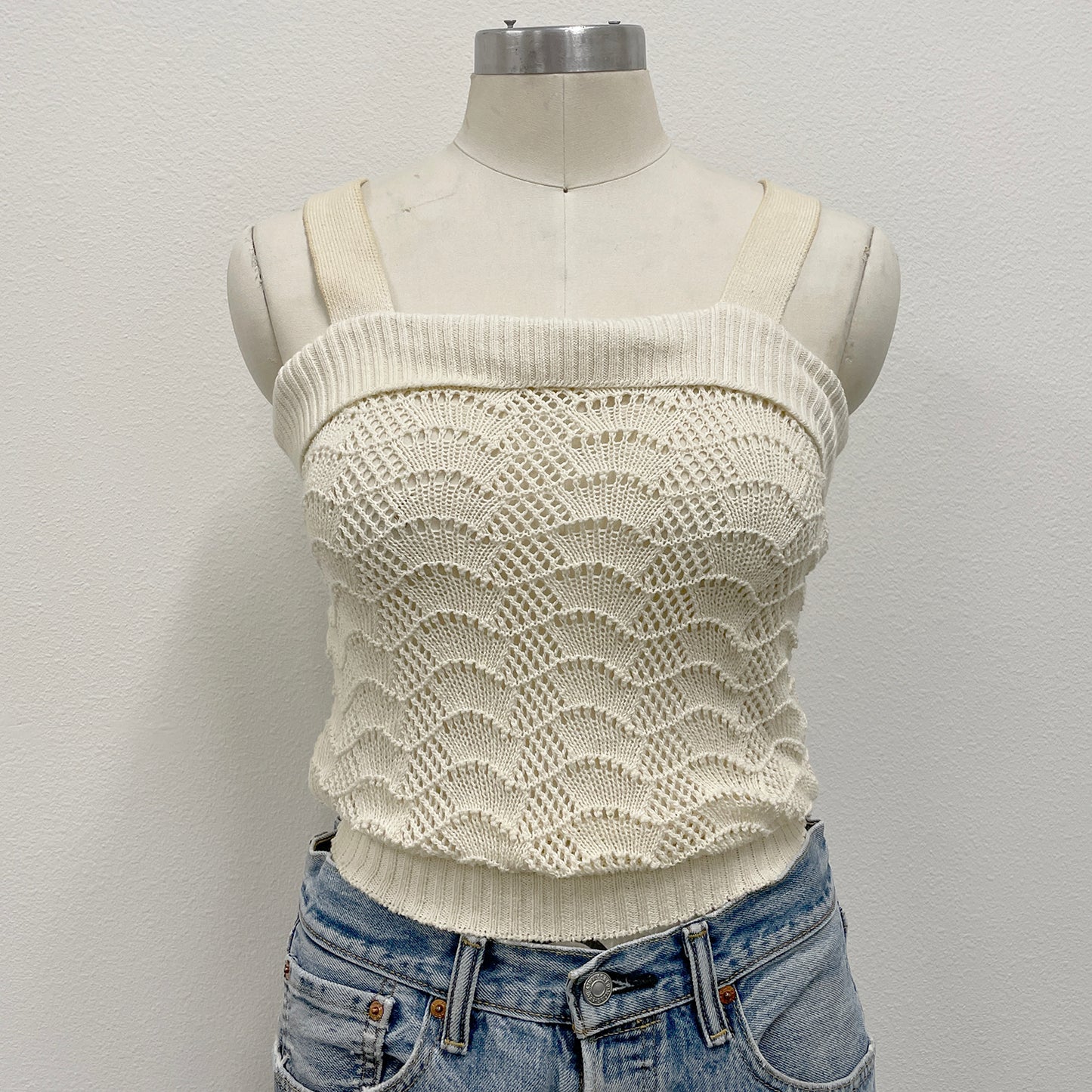 White crochet knitted tank top on a mannequin 