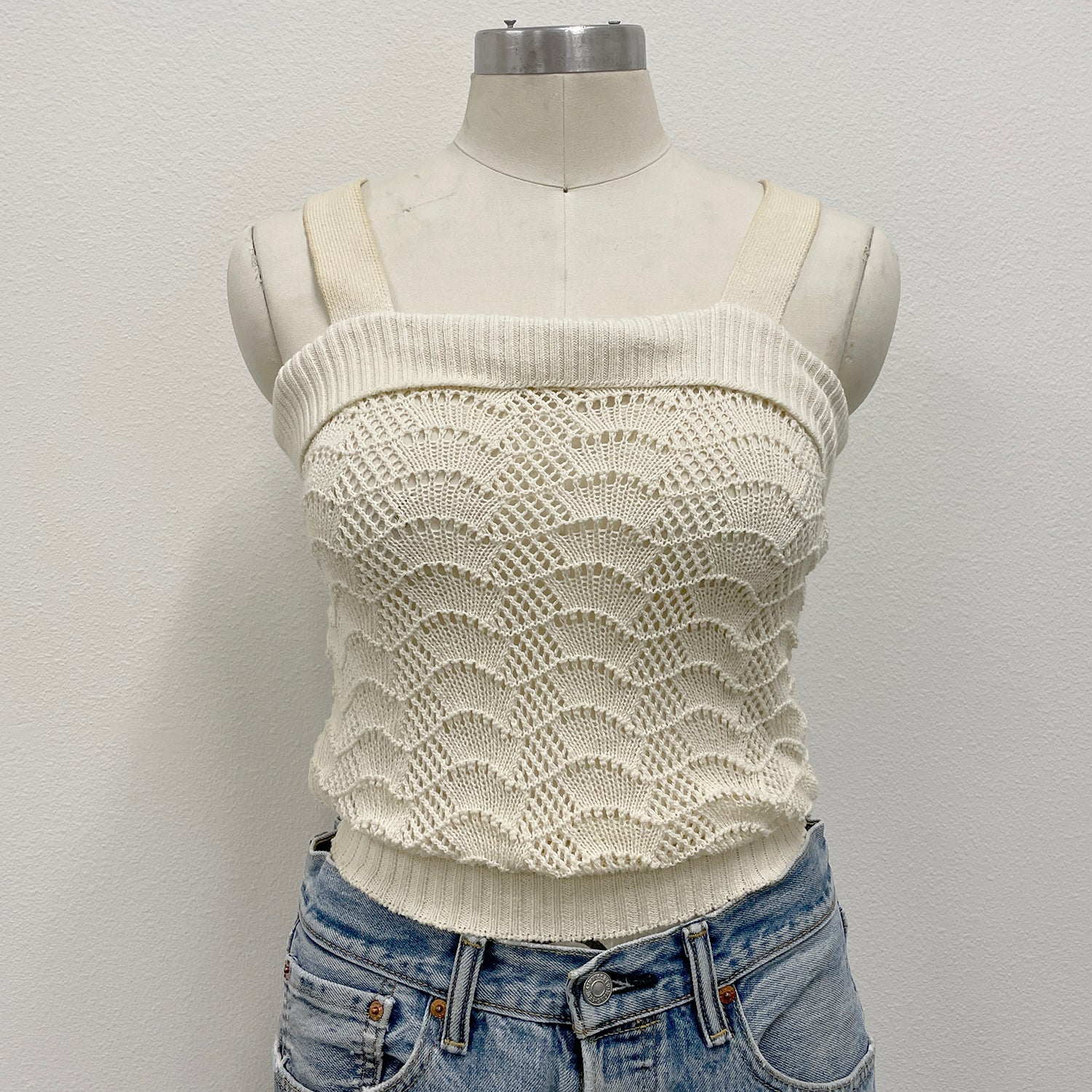 White crochet knitted tank top on a mannequin 