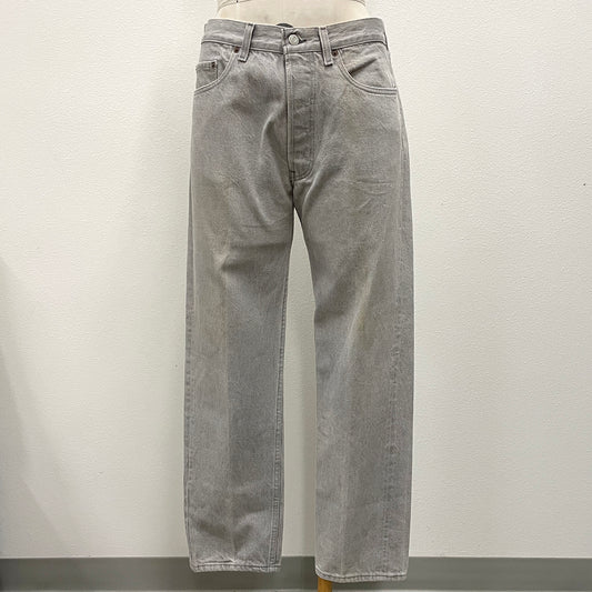 Light gray washed denim jeans displayed on a mannequin torso against a plain off-white wall.